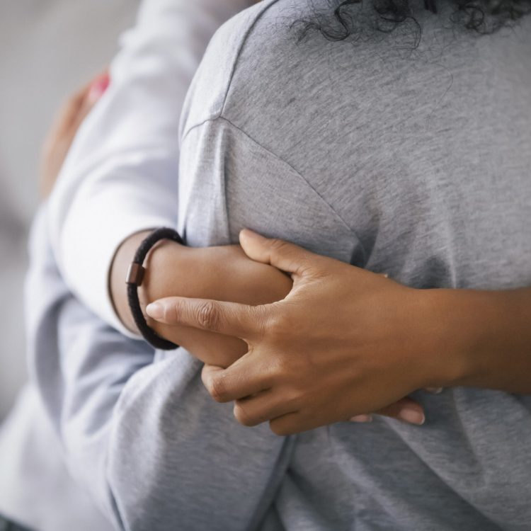 Loving african american foster care parent single mother sister embrace teen daughter giving support and protection, black mom hug teenage girl, family kindness concept, close up view, focus on hands