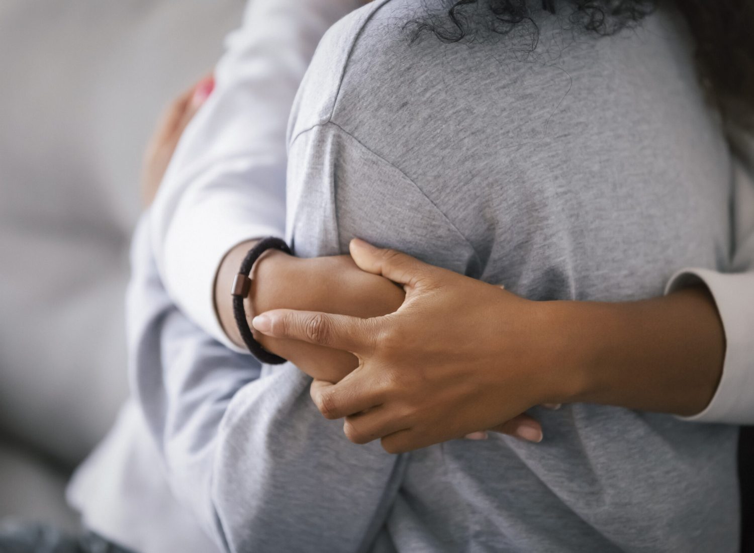 Loving african american foster care parent single mother sister embrace teen daughter giving support and protection, black mom hug teenage girl, family kindness concept, close up view, focus on hands