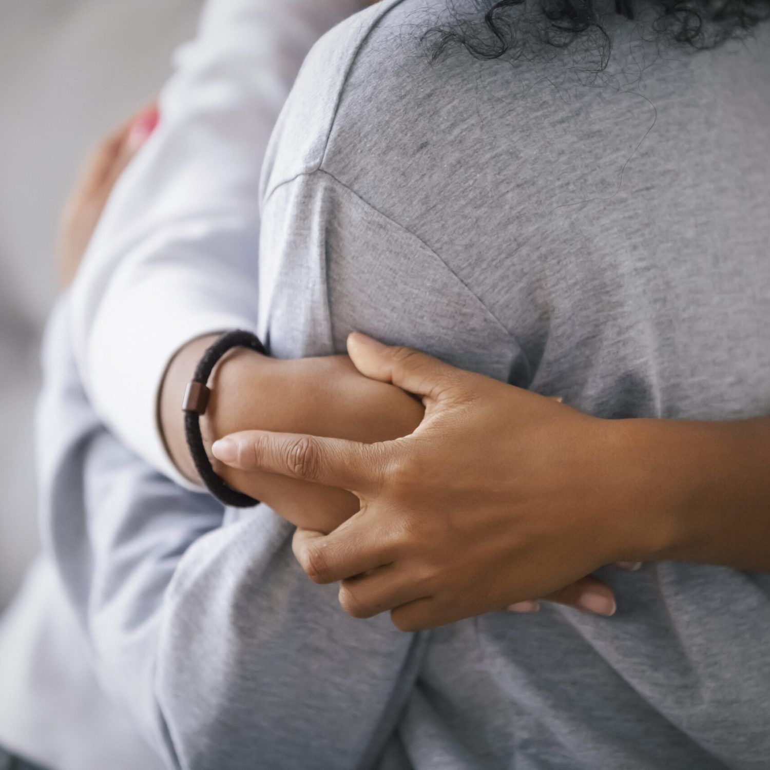 Loving african american foster care parent single mother sister embrace teen daughter giving support and protection, black mom hug teenage girl, family kindness concept, close up view, focus on hands