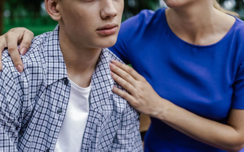 Mother supporting her upset son, listening his problems in school, bullying