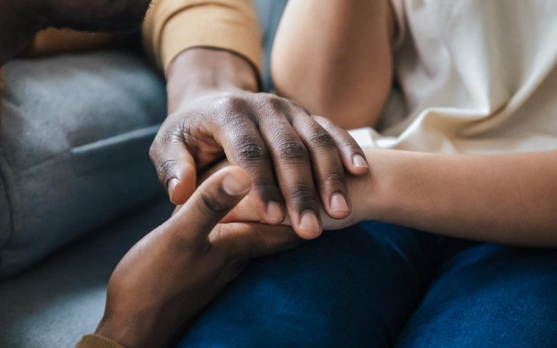 African american father dad holding hands of child as charity and support concept, children protection, kid adoption donation, black family love care connection, parenthood, upbringing, close up view