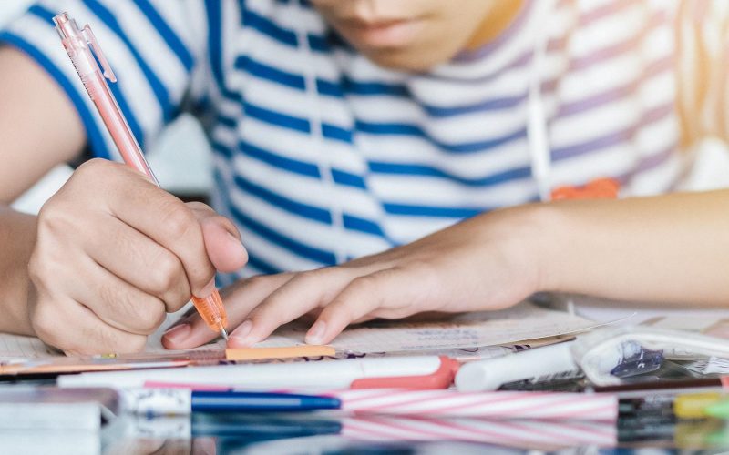 Education, back to school and literacy day concept with girl kid student studying doing homework writing on desk