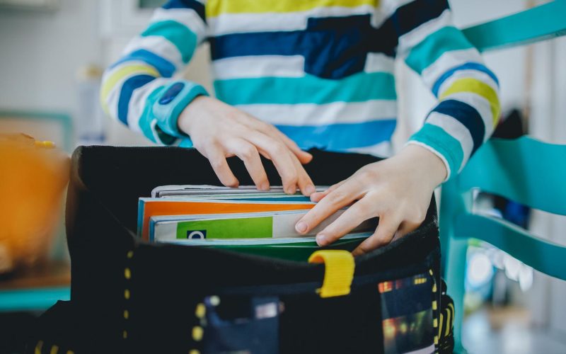 Boy packing his school bag