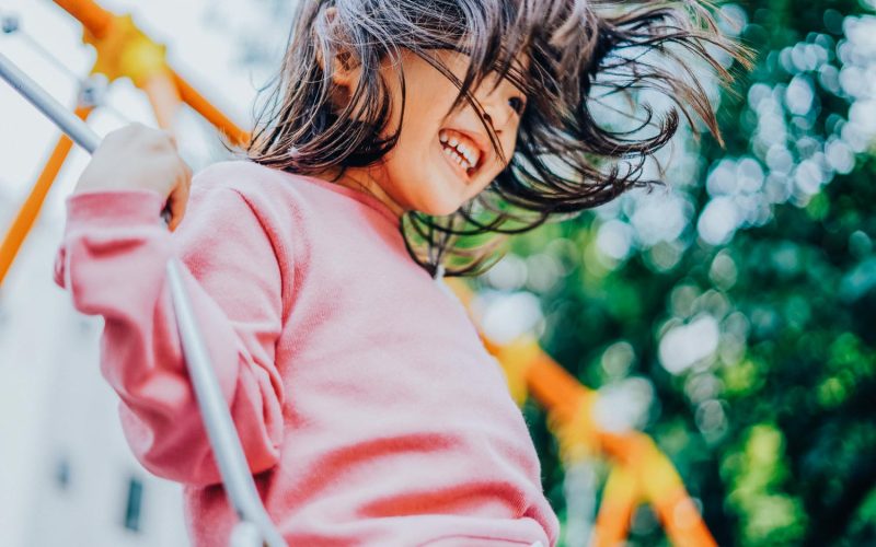 Girl playing with swing at a park