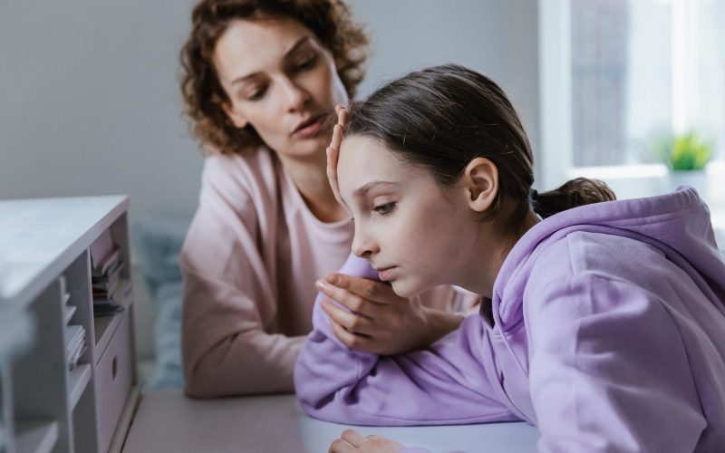 Affectionate mother giving psychological support to depressed young teen kid daughter. Stressed adolescent child girl feeling abused or suffering from bullying, parental help and devotion concept.