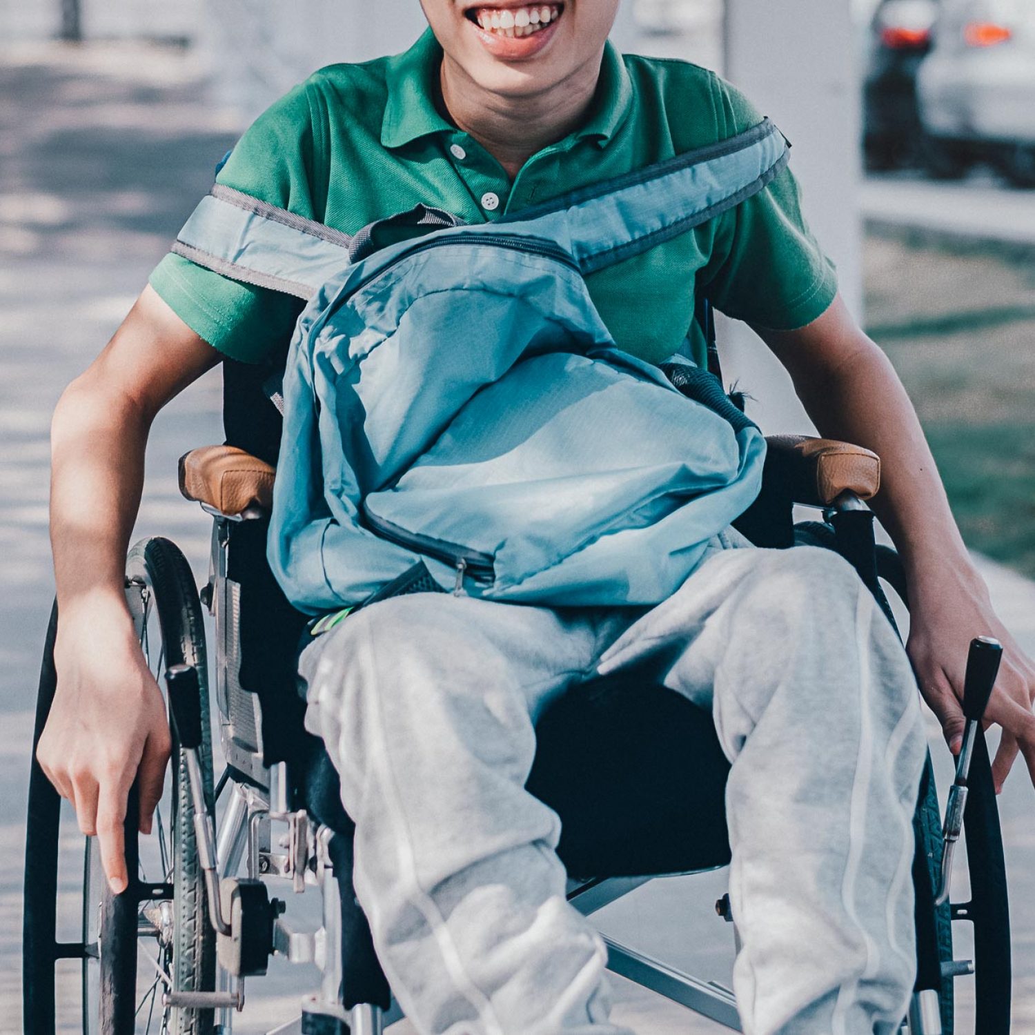 Confident Asian disabled teen boy on wheelchair determining to use wheelchair by himself, Lifestyle in the education age of special need kid, Muscle and self-esteem development concept.