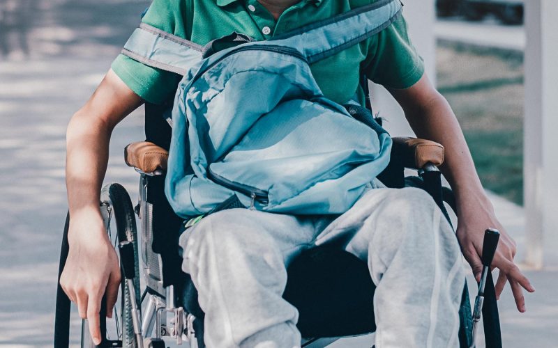 Confident Asian disabled teen boy on wheelchair determining to use wheelchair by himself, Lifestyle in the education age of special need kid, Muscle and self-esteem development concept.