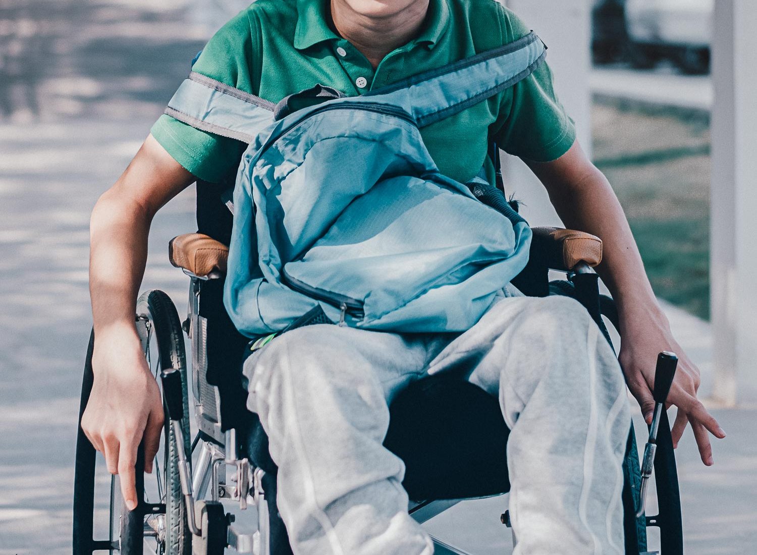 Confident Asian disabled teen boy on wheelchair determining to use wheelchair by himself, Lifestyle in the education age of special need kid, Muscle and self-esteem development concept.