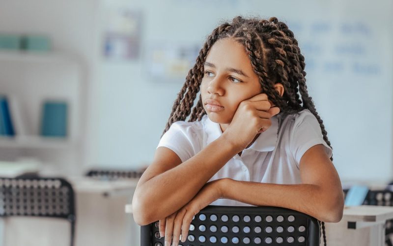 Sad African-American girl at school. Stop racism