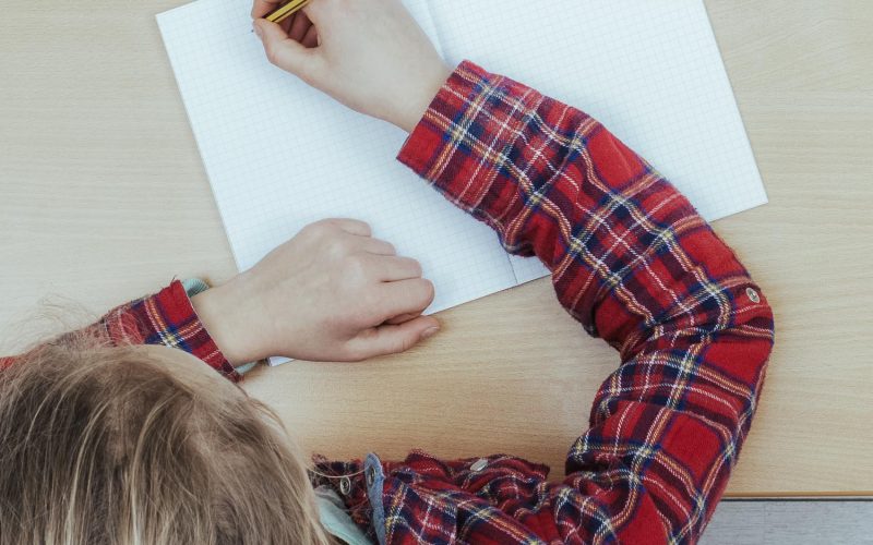 school girl sitting behind desk in classroom header image
