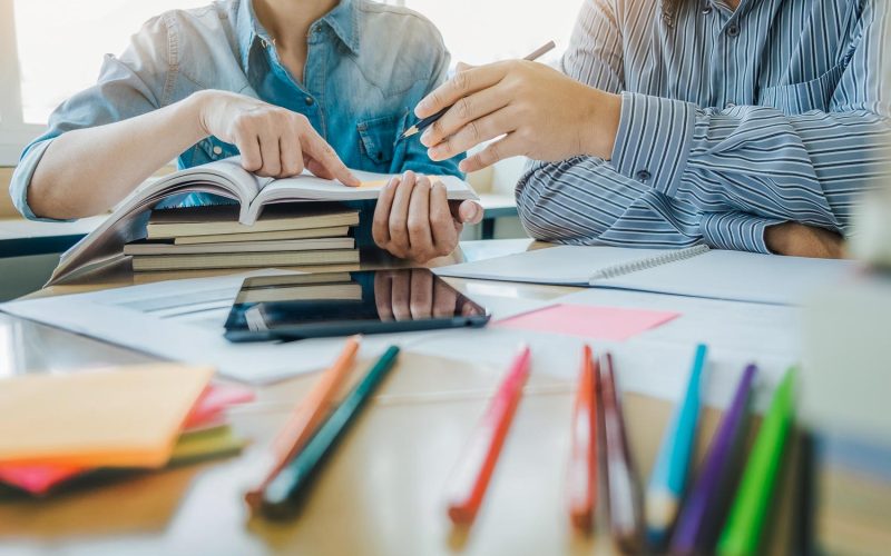 Young students campus helps friend catching up and learning tutoring. People, learning, education and school concept.