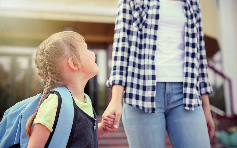Mother taking daughter to school